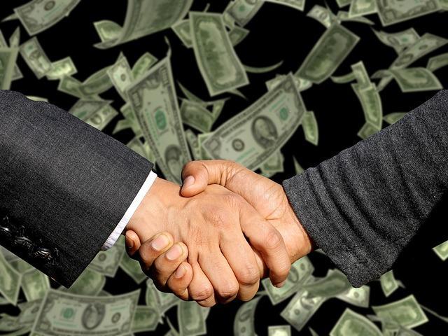 Handshake symbolizing a closed deal between investors, representing trade, agreement, and capital flow in private market transactions.